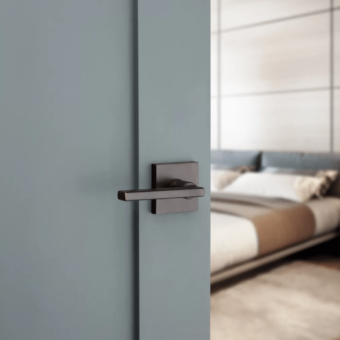 Kwikset Halifax square non-locking passage door lever in Venetian bronze finish, ideal for residential use.