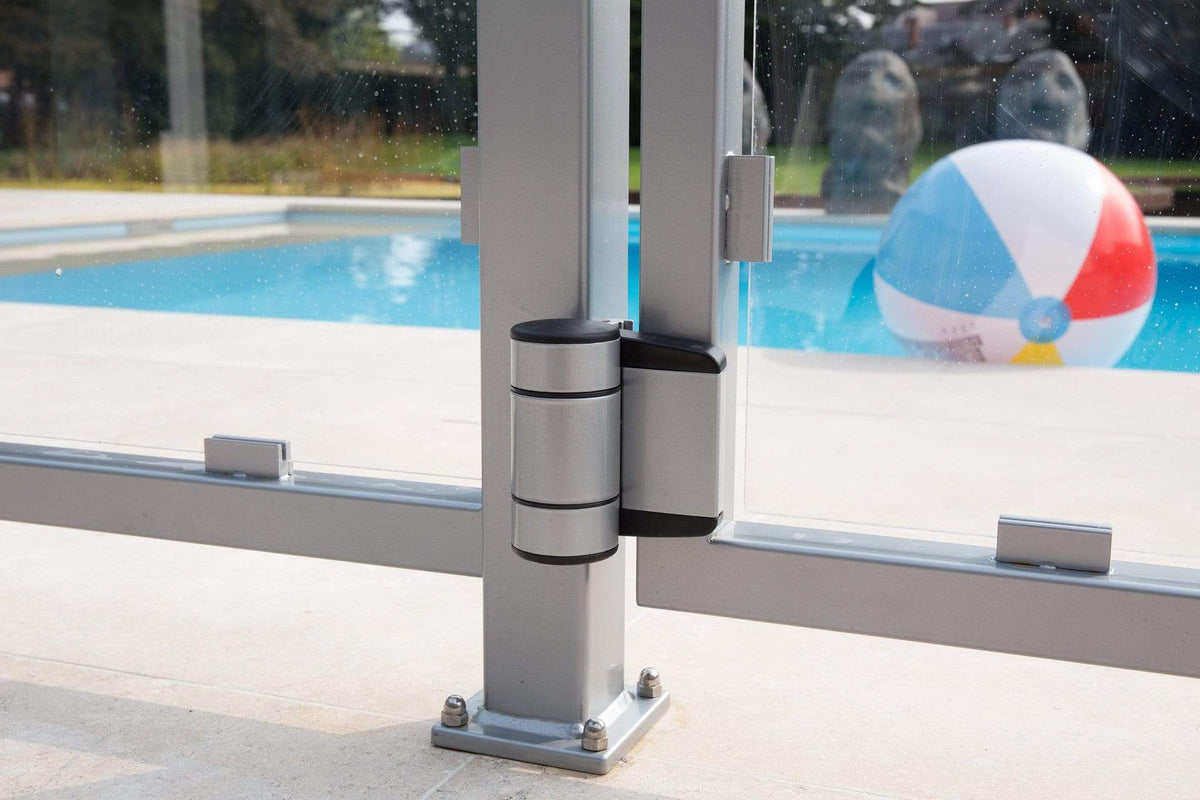 Two-way adjustable double bearing gate hinges installed on a glass gate, supporting gates up to 330 lbs, near a pool.