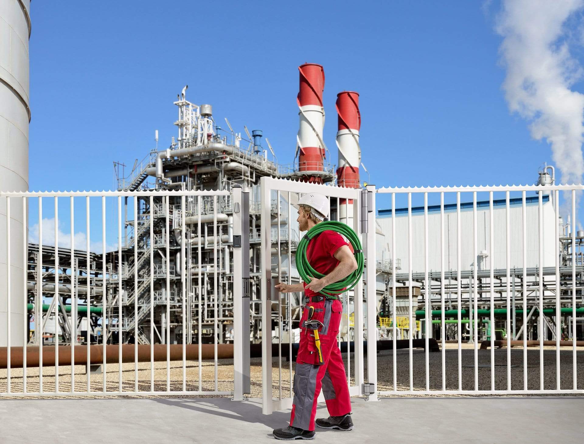 Two-way adjustable double bearing gate hinges for gates up to 330 lbs, shown in an industrial setting with a worker.