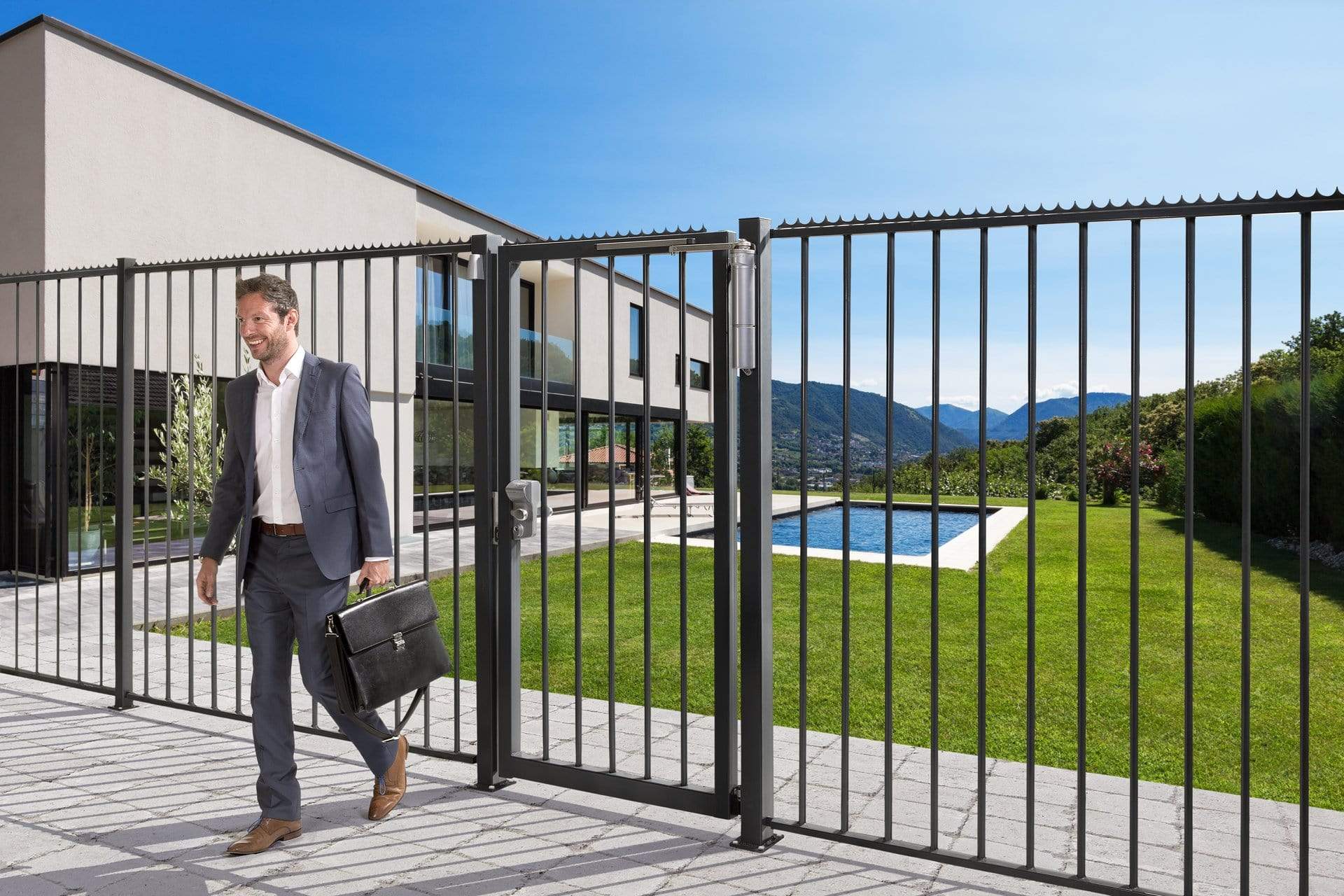 Surface mounted mechanical code lock for gates, suitable for square or flat profiles, shown on a stylish gate.