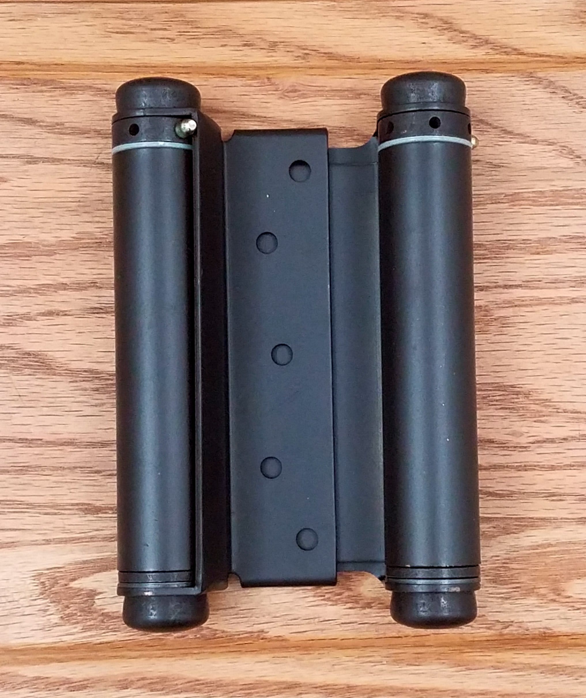 Adjustable double action spring hinges in oil rubbed bronze, measuring 4 to 6 inches for versatile door applications.