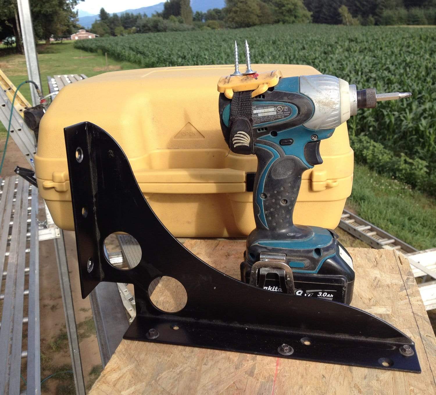 Prohold adjustable magnetic wrist strap organizer for tools, featuring a drill and a sturdy metal bracket on a work surface.