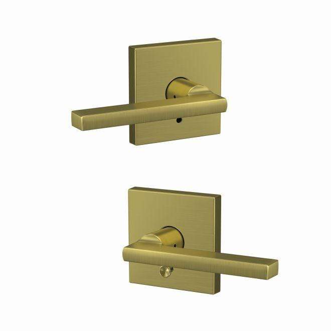Satin brass Schlage custom residential door lever with combined passage and privacy lock in Latitude style and Collins rose trim.