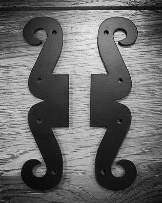 Scrolled decorative dummy hinge in black powder coat finish, measuring 1-1/2" x 7-1/2", sold individually.