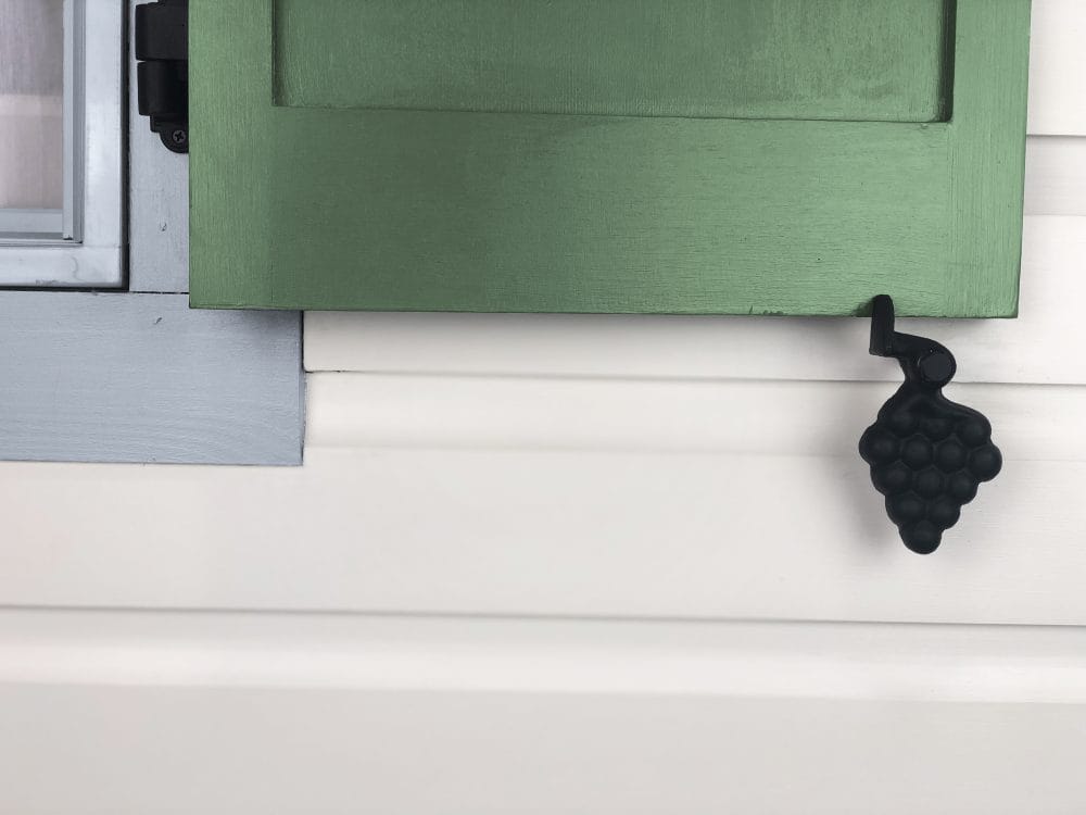 Black powder-coated cast iron shutter dogs in JP Style #30-L Grape design, 5-1/2 inches, sold in pairs.