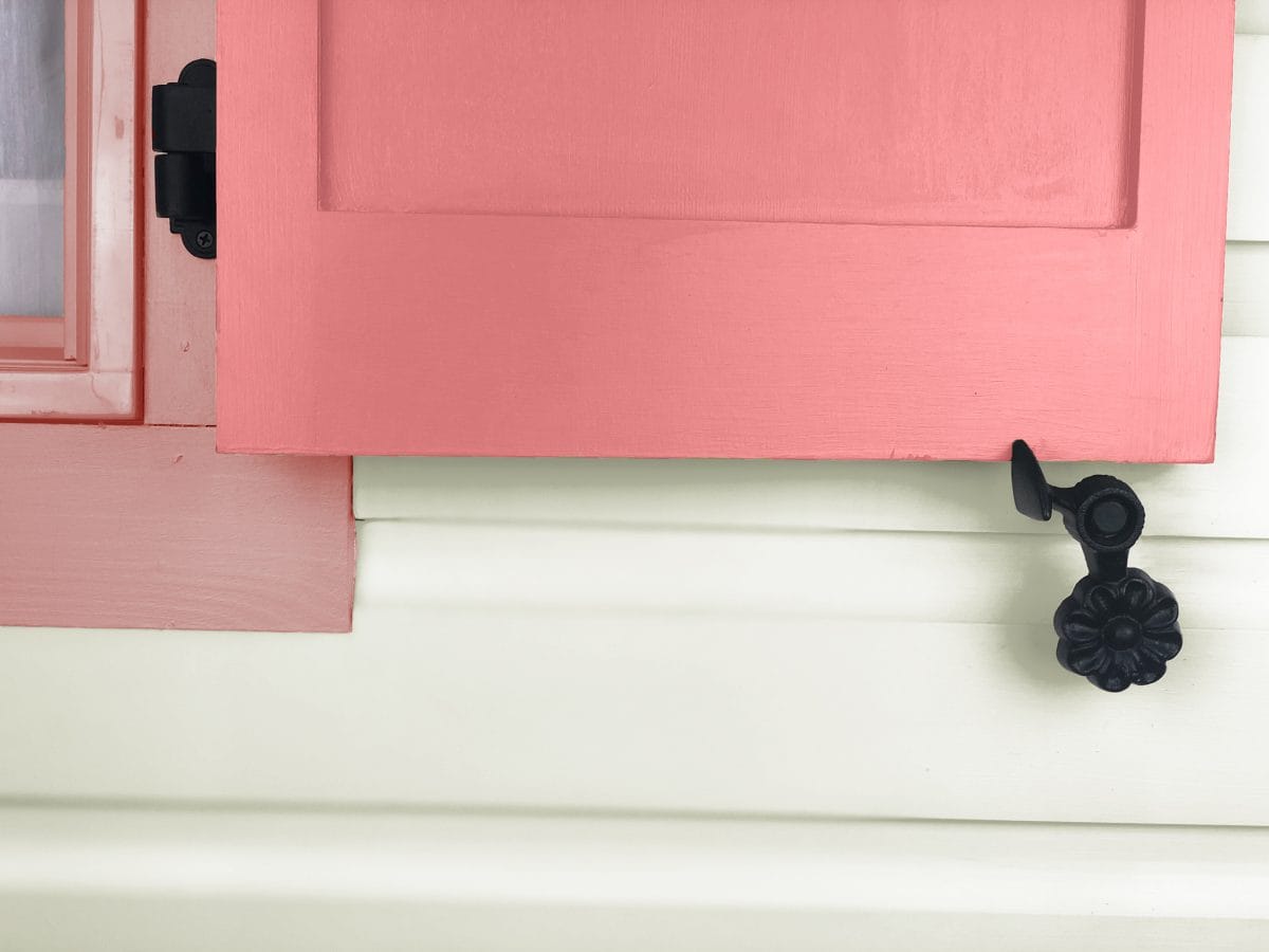 Black powder-coated cast iron shutter dogs in a flower design, 4-1/2 inches, sold in pairs for securing shutters.