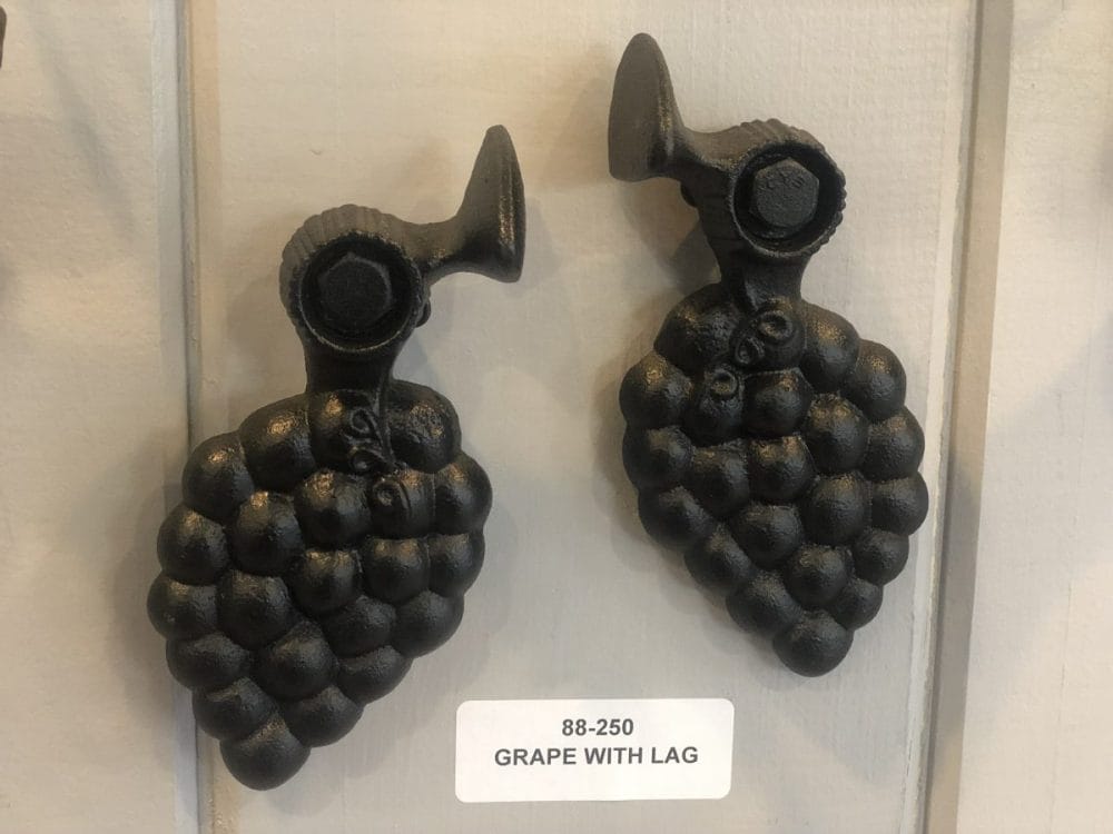 Cast iron grape-shaped shutter dogs in black powder coat, 6-1/4 inches, sold in pairs for securing shutters.