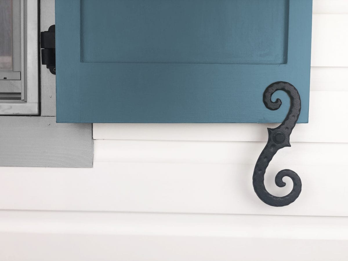 Large 8-inch cast iron shutter dogs in black powder coat, designed to hold shutters open, sold in pairs.