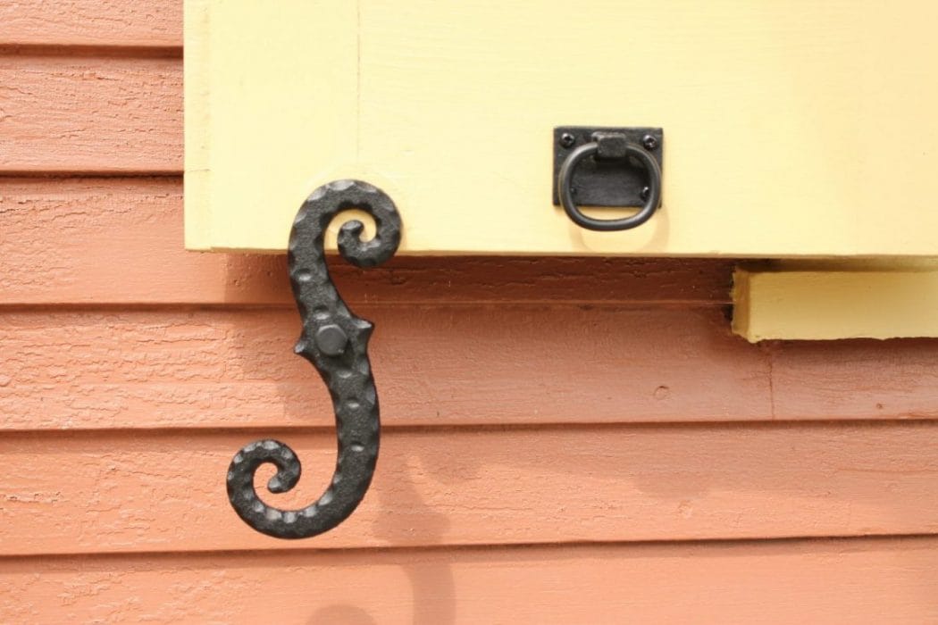 Cast iron shutter dogs and tiebacks in black powder coat, 6-3/4 inches, designed for securing window shutters.