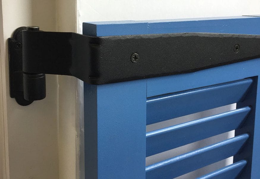 Black powder-coated strap hinge for shutters, 12 inches long with a 1.5-inch offset, featuring a circle tip design.